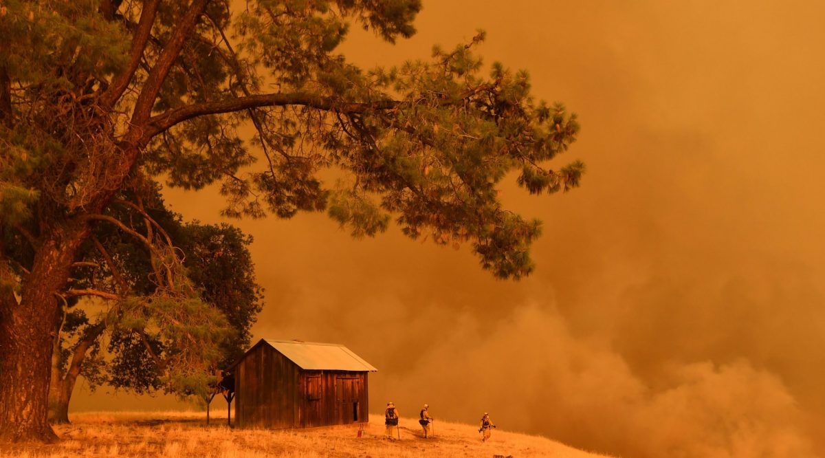 TOPSHOT - Firefighters watch as flames from the County Fire climb a hillside in Guinda, California, on July 1, 2018. - Californian authorities have issued red flag weather warnings and mandatory evacuation orders after a series of wildfires fanned by high winds and hot temperatures ripped through thousands of acres. The latest blaze, the County Fire sparked in Yolo County on June 30, had by July 1 afternoon spread across 22,000 acres (9,000 hectares) with zero percent containment, according to Cal Fire. (Photo by JOSH EDELSON / AFP)        (Photo credit should read JOSH EDELSON/AFP/Getty Images)